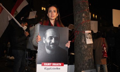 Woman holds poster of man