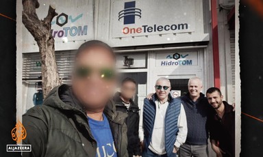 A group of men pose for a picture. Two faces are blurred 