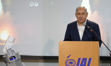 Man stands behind a lectern 