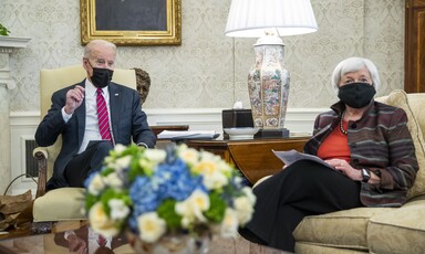 Man and woman in face masks sit on chairs