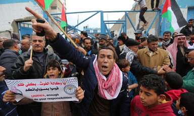 People carry flags and banners during a protest 