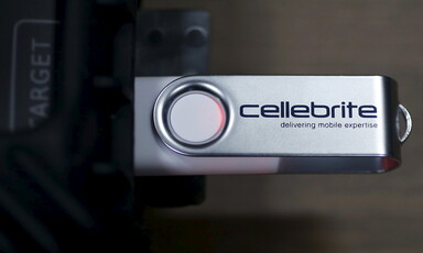 A USB with "Cellebrite" written on it is plugged into a device