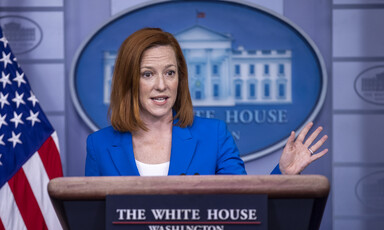 Woman at podium gesticulates