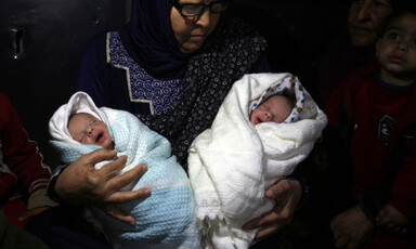 Woman holds two babies 