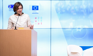 Woman stands at lectern 