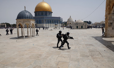 Armed soldiers with Dome of the Rock in background 