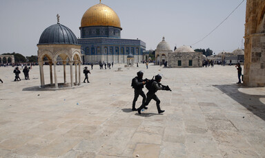 Armed soldiers with Dome of the Rock in background