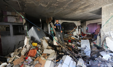 A man stands in a severely damaged building 