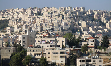 Densely-packed apartment buildings fill a landscape