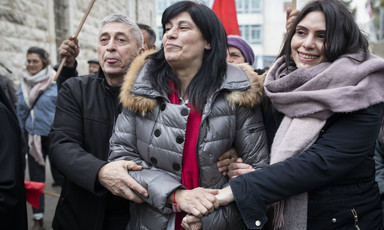 A woman is flanked by a man and a woman