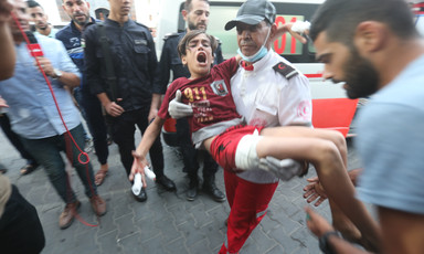 Paramedic carries wounded boy