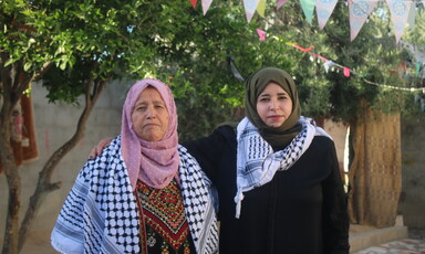 Two women pose for the camera