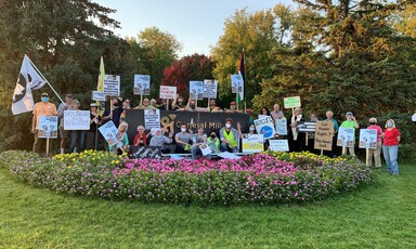 Protesters with signs pose for group photo at General Mills campus 