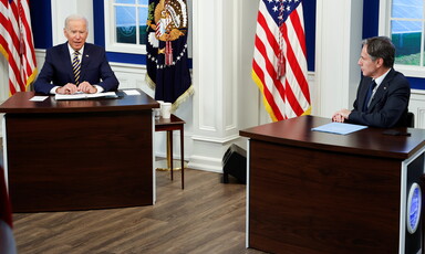 Two men seated at tables