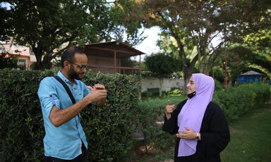 Man and woman communicate with sign language 