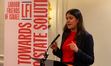 A woman speaks from a lectern