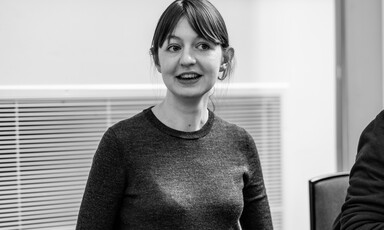 Woman in crewneck and bangs in black and white picture 