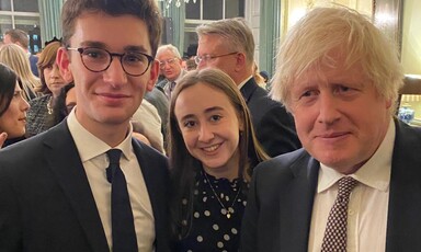 Three people posing at a reception