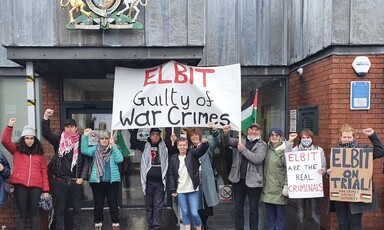 Protesters with signs outside a court