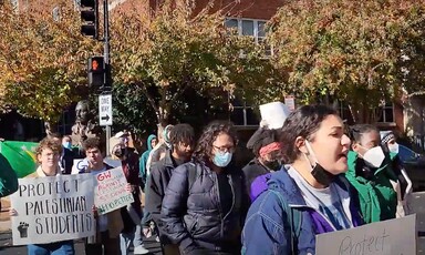 Students hold signs during a protest