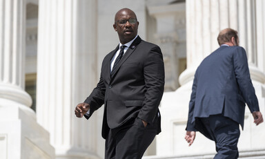 Two men in suits with their backs towards one another