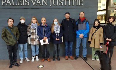 People stand together in front of modern building