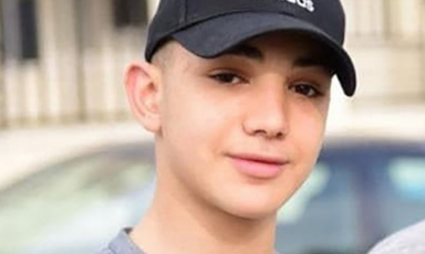 A teenager wearing a baseball cap