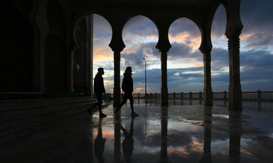 The arches of a mosque are silhouetted against a brooding winter sky over Gaza's beachfront.