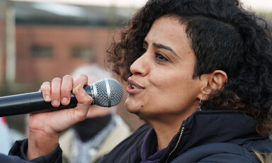 A woman speaks into a microphone