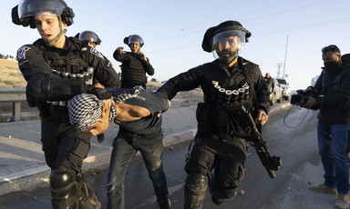 Heavily armed Israeli police arrest a young boy 