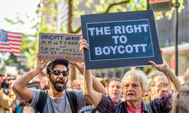 Protesters hold signs