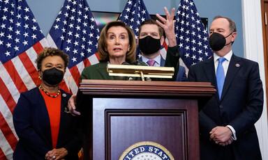 Members of Congress stand at podium