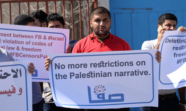 People hold signs against social media censorship
