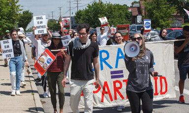 People march and carry signs