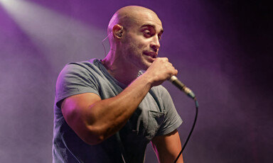 A man on stage holding a microphone