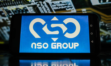 A tablet displays the NSO Group logo