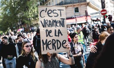 Large crowd holding signs and marching