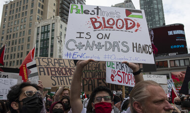 Protesters hold signs