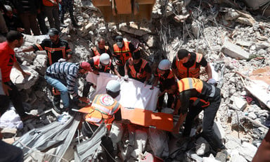 First responders search amid the rubble of bombed buildings 