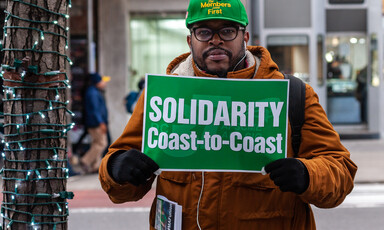 A man holds a sign