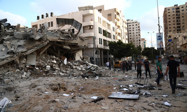 A scene of destruction beside a large building 