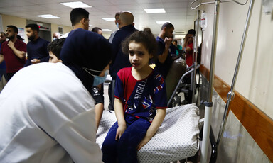 A young girl is treated on a hospital bed