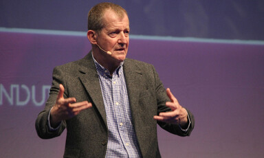 Man with microphone on a stage 