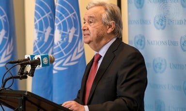 Man speaks at podium in front of UN flag