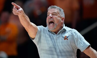 A coach points during basketball game