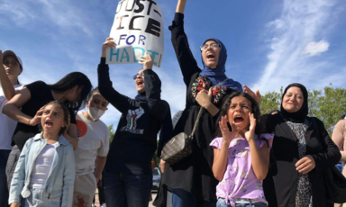 Women and children protesters chant and hold up signs in support of a teen beaten by police in Chicago