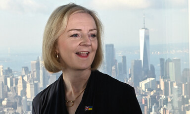 Liz Truss smiles on the backdrop of the New York skyline