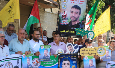 People hold posters, banners and flags 