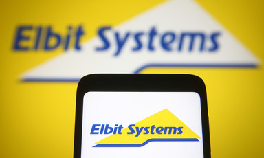 The words Elbit Systems on both a mobile phone and a larger screen