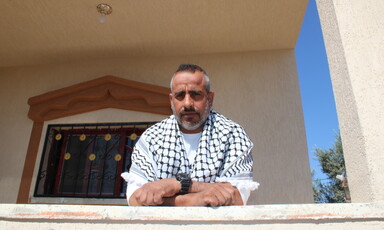 Man wearing a chequered black and white scarf 